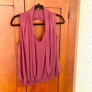 Maroon open back sleeveless top.